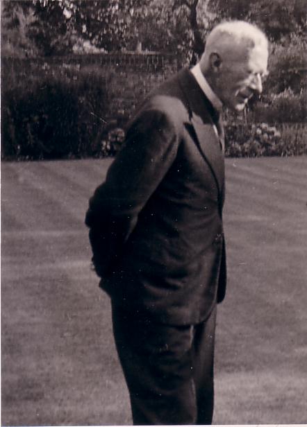 Francis Bergh, pensive, standing on lawn